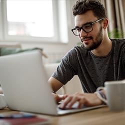 Man using laptop for mobile banking